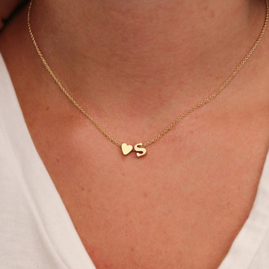 Necklace with an initial accompanied by a small heart